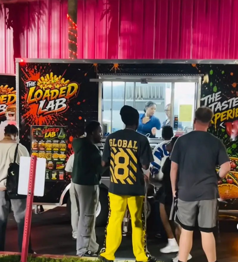 Customers lining up at The Loaded Lab food truck at night
